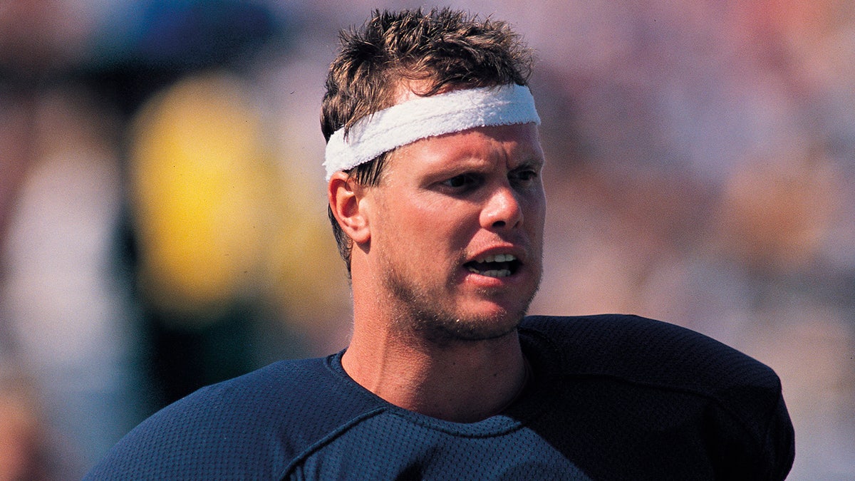 Jim McMahon looks on