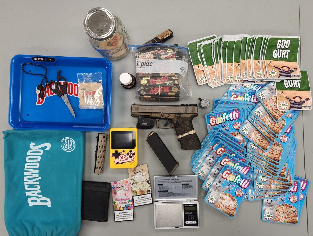 marijuana, scales, packaging equipment, and a weapon.